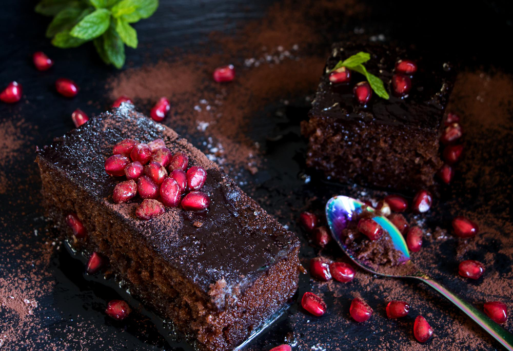 Brownie z buraków i czekolady posypane granatem i polane sosem czekoladowym